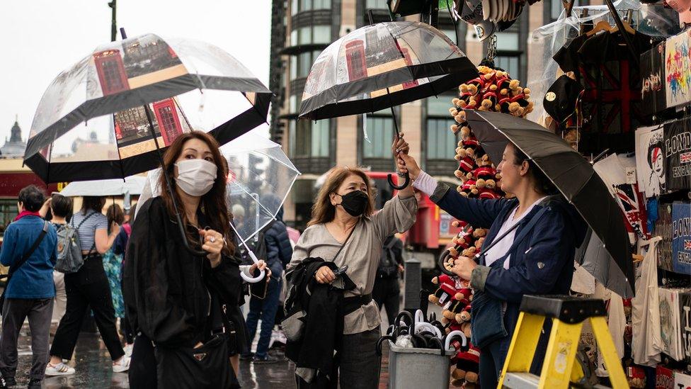 Women purchasing umbrellas in Westminster