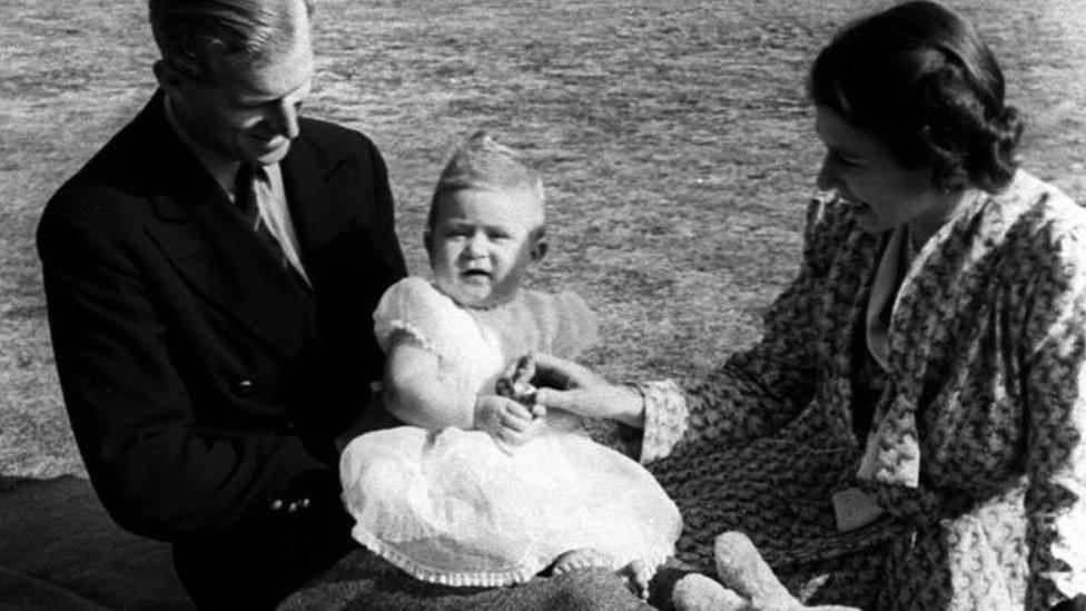 A baby Prince Charles with his parents, the Duke of Edinburgh and the Queen