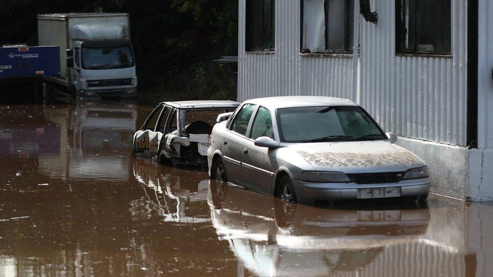 Cars submerged in water as the River Dennet in Londonderry burst its banks