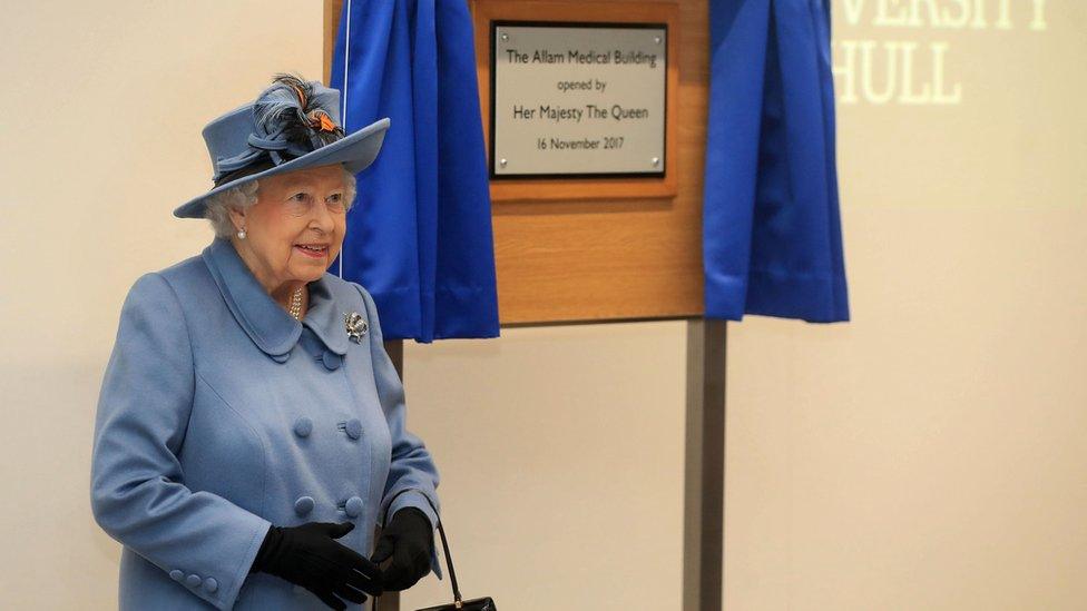 The Queen standing in front of a plaque