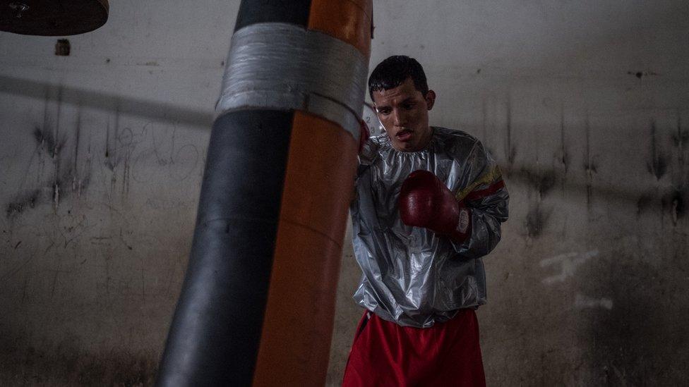 Boxer Robin Zamora trains with a punch bag