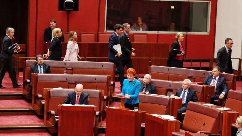 Greens senators walk out of the chamber during Ms Hanson's speech