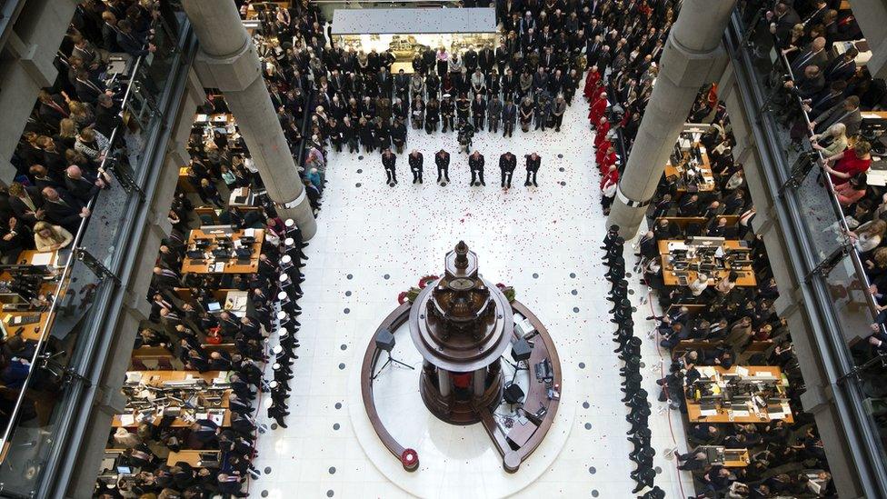 Workers at Lloyd's of London gather to remember 100 years since the start of World War One.