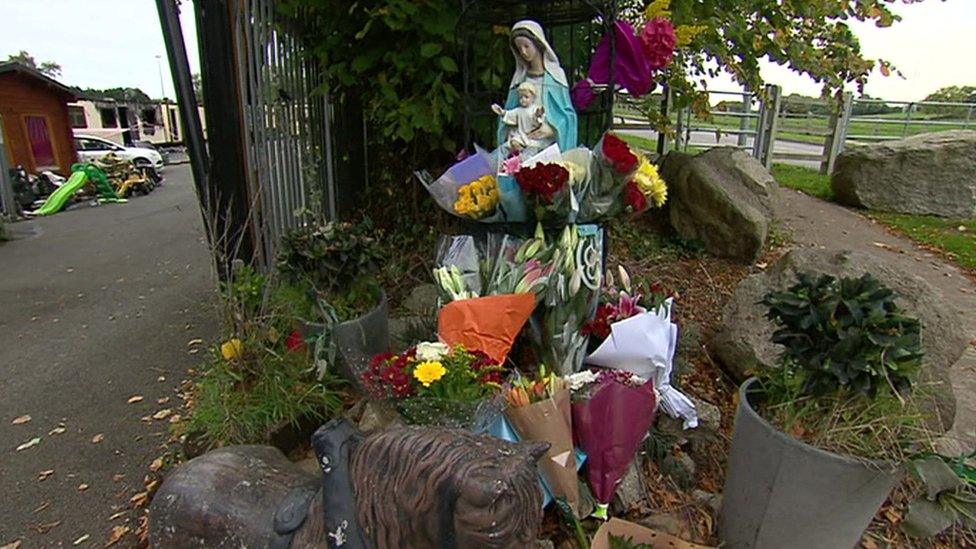 Flowers placed at the scene of the fire