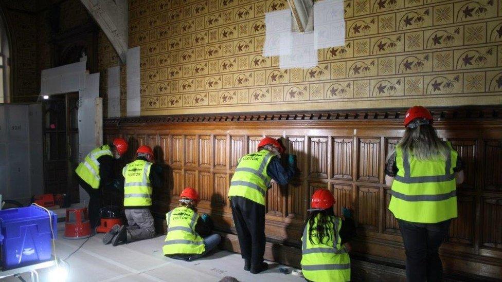 Volunteers cleaning wood panelling