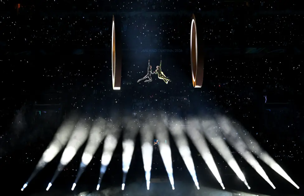 Two aerial actors are suspended in the San Siro during the opening ceremony