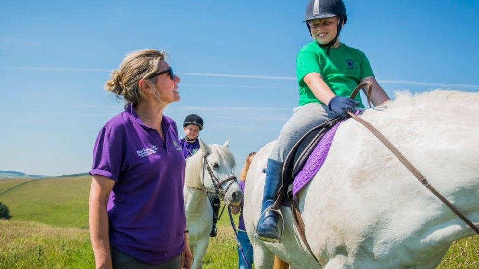 Children enjoying a hack above the stables outside Selkirk