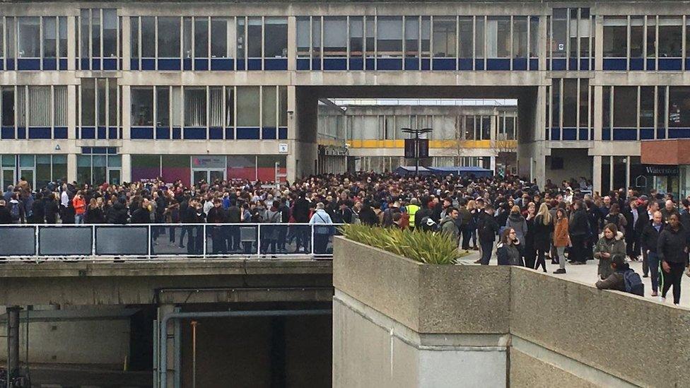 Students mill in the squares after the evacuation