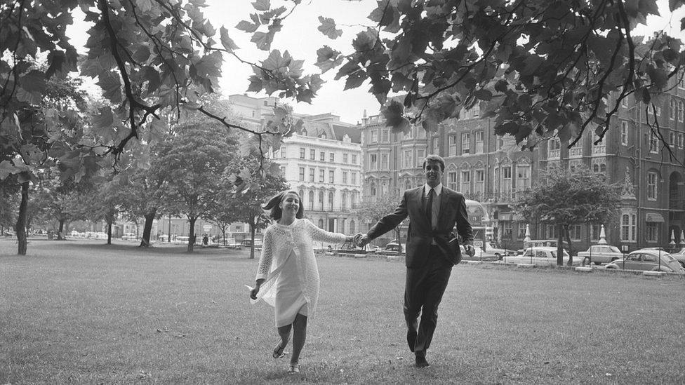 England footballer Geoff Hurst and his wife Judith on their way to the Royal Garden Hotel in Kensington for a reception held to celebrate the World Cup victory, 31st July 1966. (Photo by Terry Fincher/Express/Getty Images)