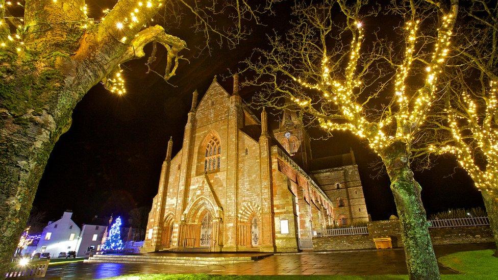 Christmas lights on the trees outside the cathedral