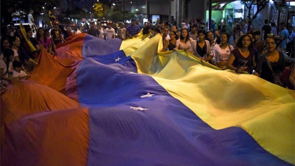 Venezuelan opposition supporters celebrate the results of the legislative election in Caracas on 7 December, 2015