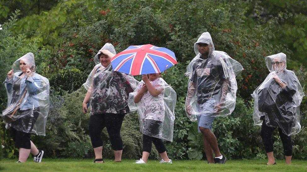 Visitors walk through the Kensington Palace gardens on the anniversary of Diana's death