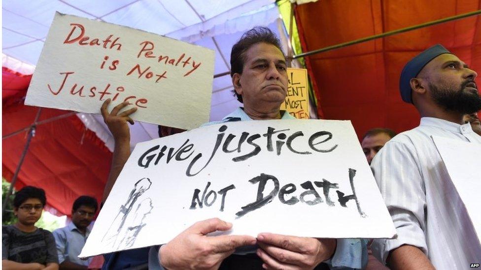 Indian social activists hold placards during a protest against capital punishment in New Delhi on July 30, 2015