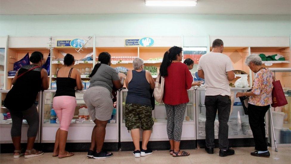 Cubans queue for products in a state shop in Havana