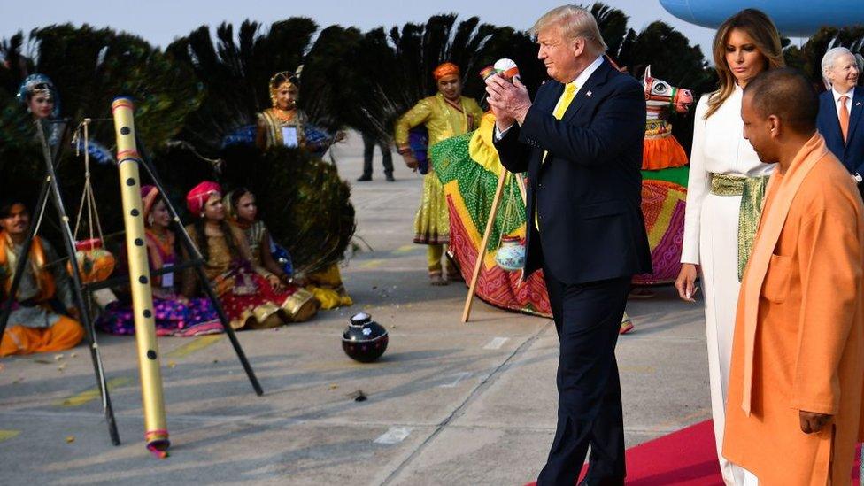 US President Donald Trump and First Lady Melania Trump are greeted by performers wearing traditional costumes as they arrive at Agra Air Base in Agra on February 24, 2020.