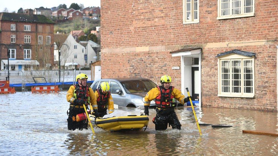 Fire and Rescue officers use an inflatable raft in Bewdley, Worcestershire