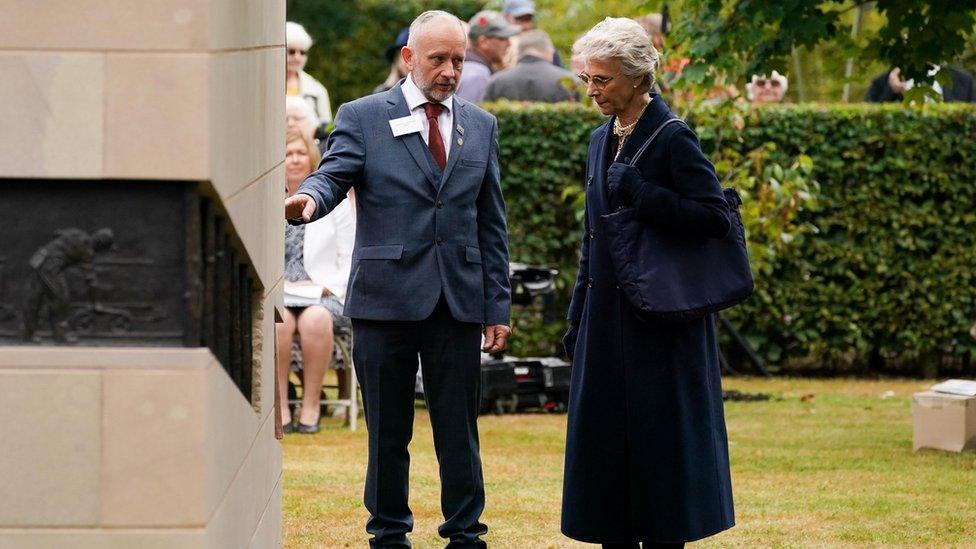 The Duchess of Gloucester speaks to the artist of the memorial Andrew DeComyn after the unveiling