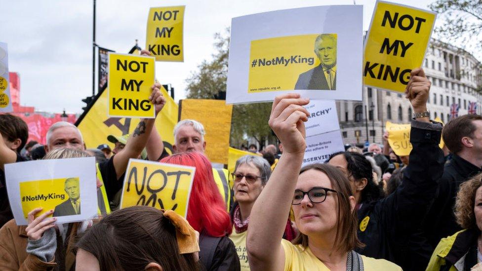 Protestors with placards saying "Not my King"