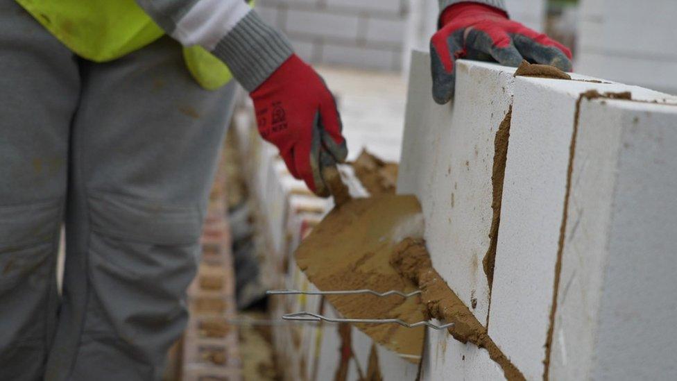 Construction worker laying bricks