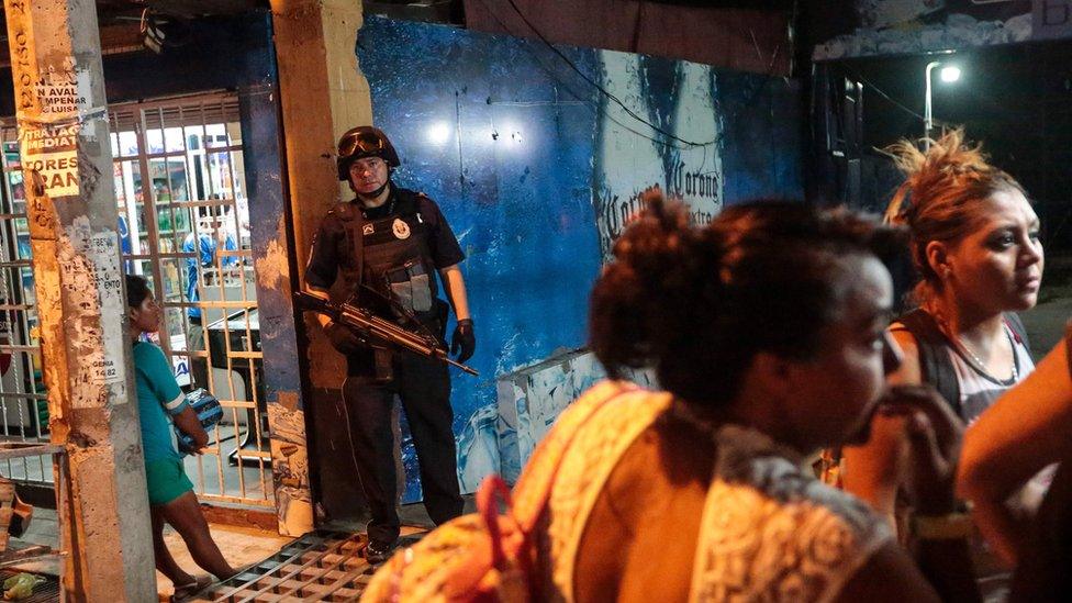 A Federal Police officer stands at the entrance of a bar where a man was shot dead by gunmen, in Acapulco, Mexico on July 16, 2016.