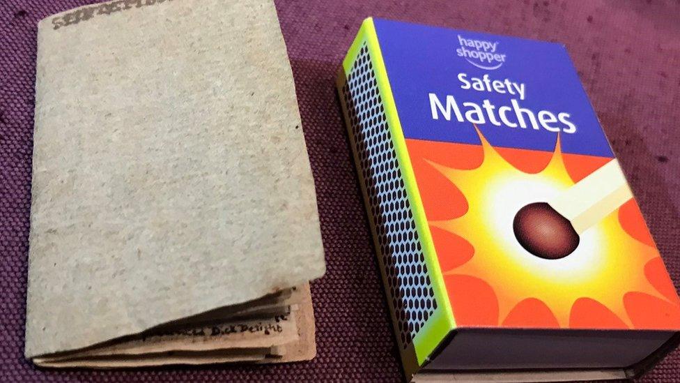 Book pictured next to a box of matches