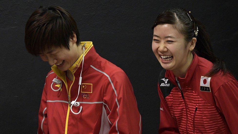 Olympic table tennis players Ai Fukuhara (R) of Japan and Ning Ding of China share a laugh following a press conference at Riocentro complex in Rio de Janeiro