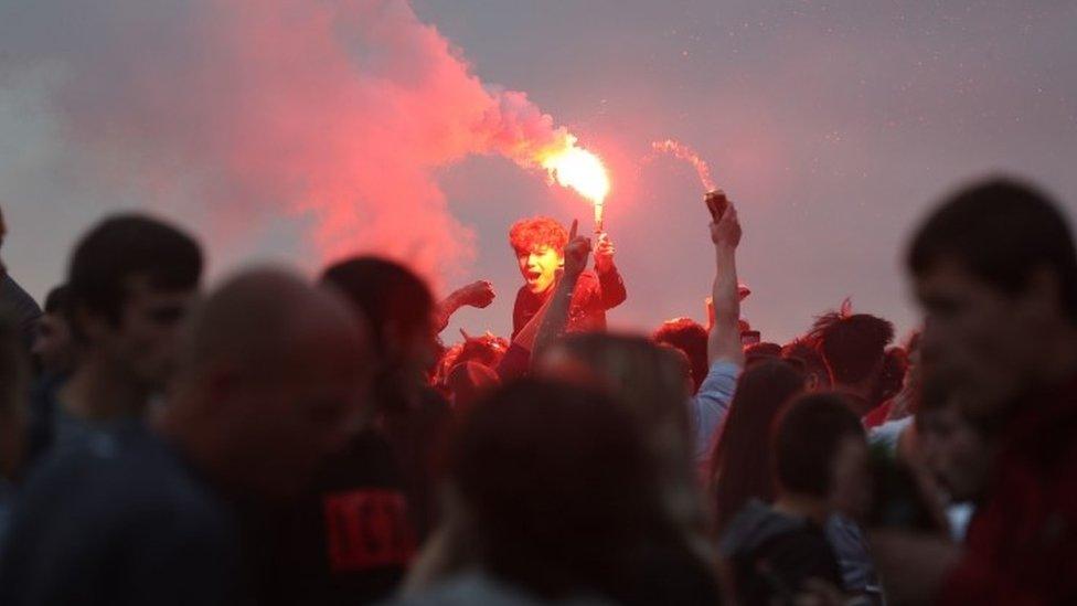 Liverpool fans let off flares outside the Liver Building in Liverpool. PA Photo. Picture date: Friday June 26, 2020