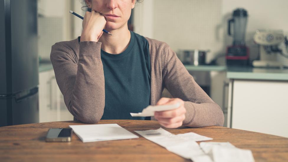 Woman studying bills and receipts