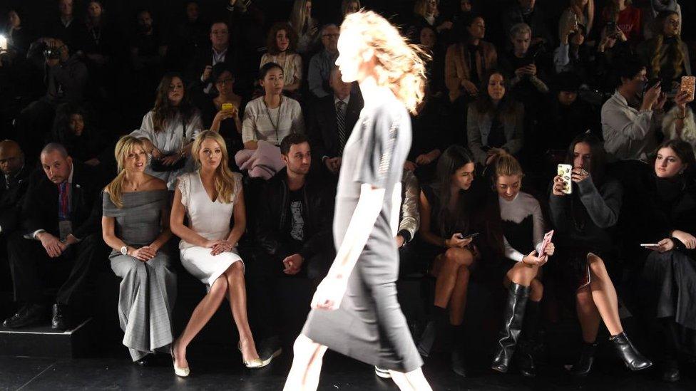 A model walks in front of the audience at a Taoray Wang show. Left-right: Marla Maples, Tiffany Trump, Ross Mechanic and others. February 11, 2017 in New York City, USA.