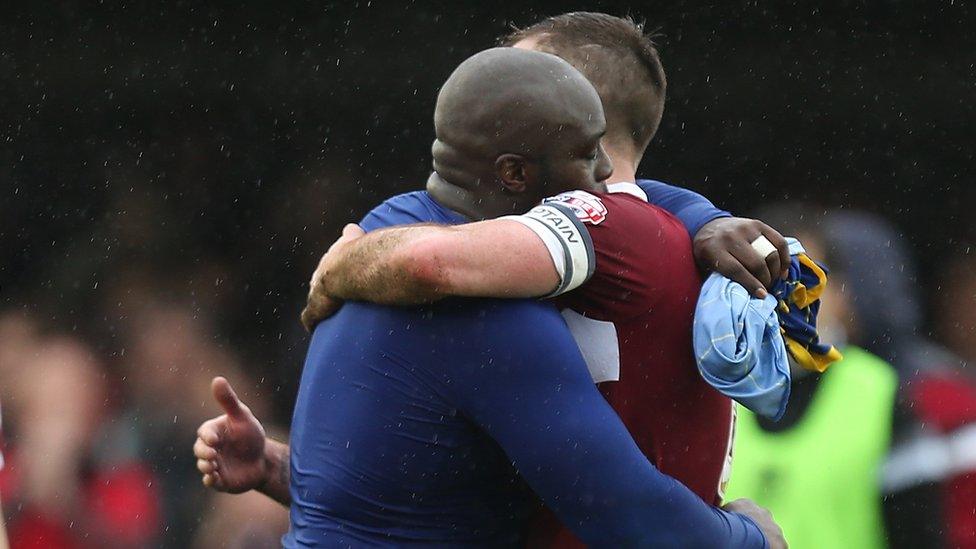 Former Northampton Town team mates Adebayo Akinfenwa of AFC Wimbledon and Lee Collins of Northampton Town