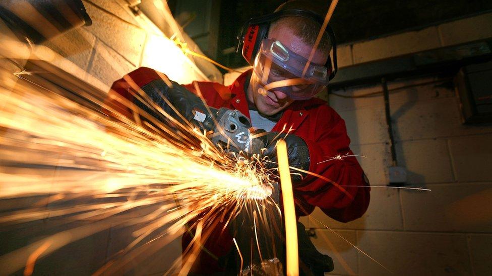 A young apprentice doing metal work in Merseyside, UK.