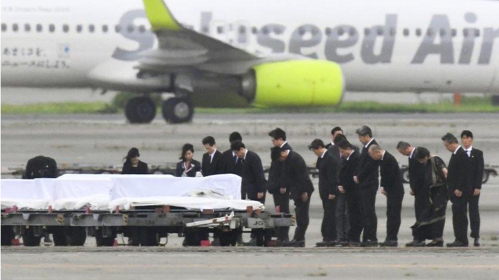 The coffins of the victims who were killed in the last weekend"s attack on a restaurant in Bangladesh, arrive at Haneda Airport in Tokyo, Tuesday, July 5, 2016