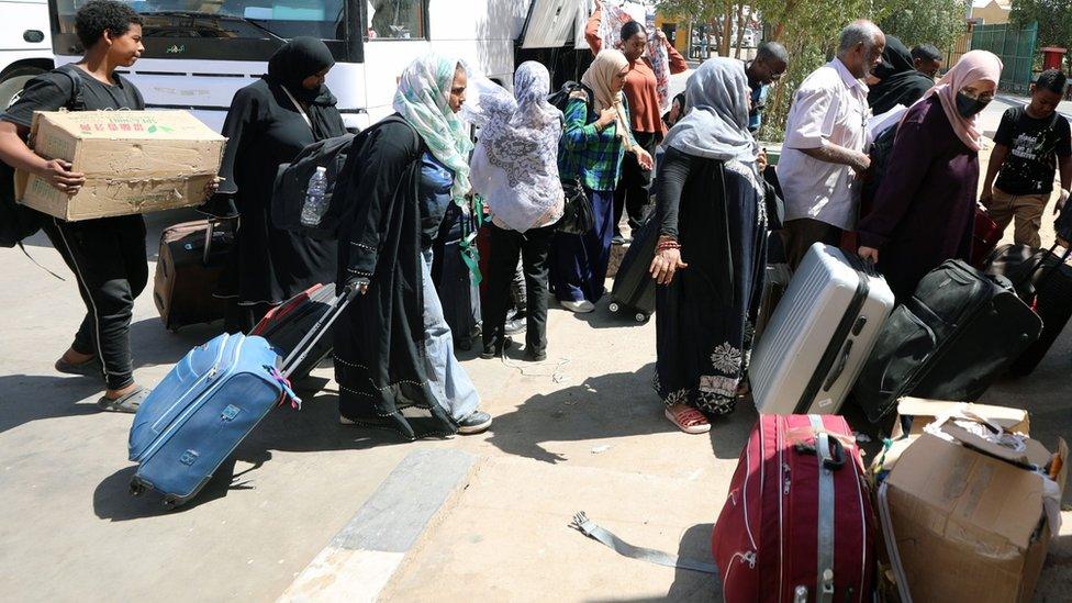 People fleeing Sudan arrive at the Qastal Land Port after crossing the border from Sudan