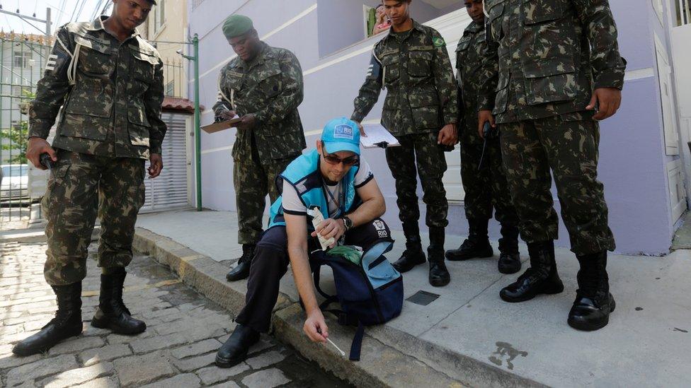 A government health agent uses larvicide to kill mosquitoes that spread the Zika virus in Rio de Janeiro