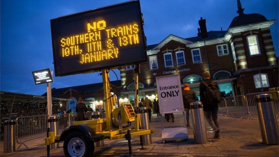 An information board advises passengers about strike action by Southern Rail outside Clapham Junction station