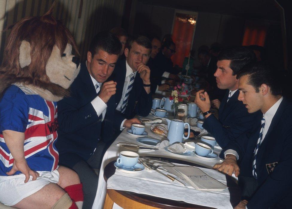 World Cup mascot World Cup Willie having afternoon tea with the West Germany squad at Ashbourne