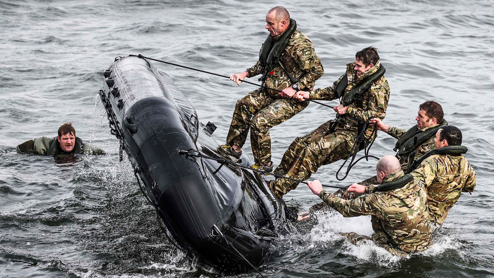 Royal Marines right a capsized dinghy