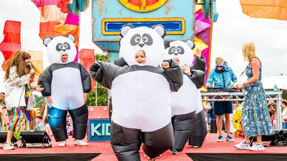 A family in inflatable panda costumes