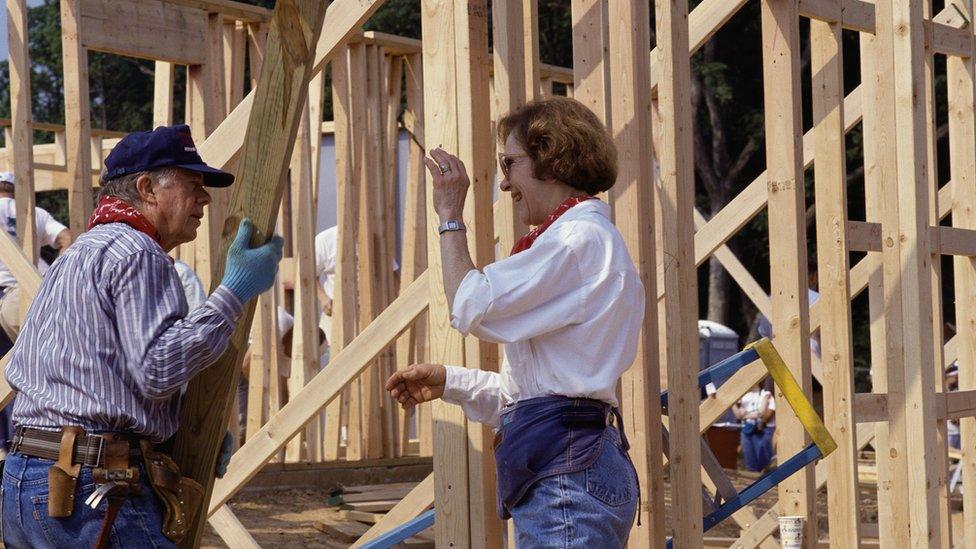 Jimmy Carter and wife Rosalynn Carter help build a house for Habitat for Humanity, 1992