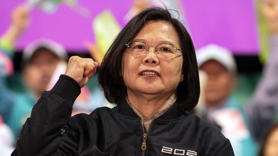 photograph shows president tsai ing-wen mid speech with her fist clenched