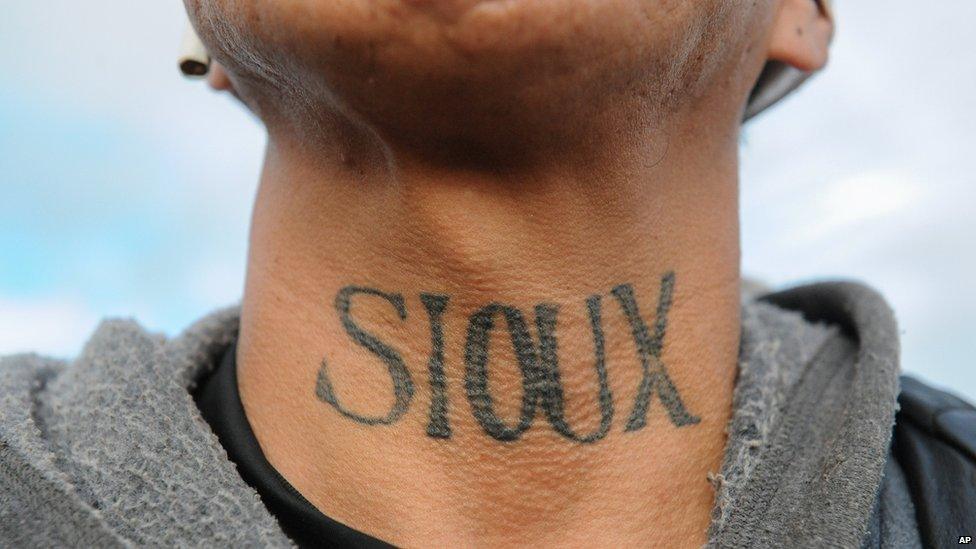 This is a photo of a Sioux Native American showing the tattoo on his neck in protest.