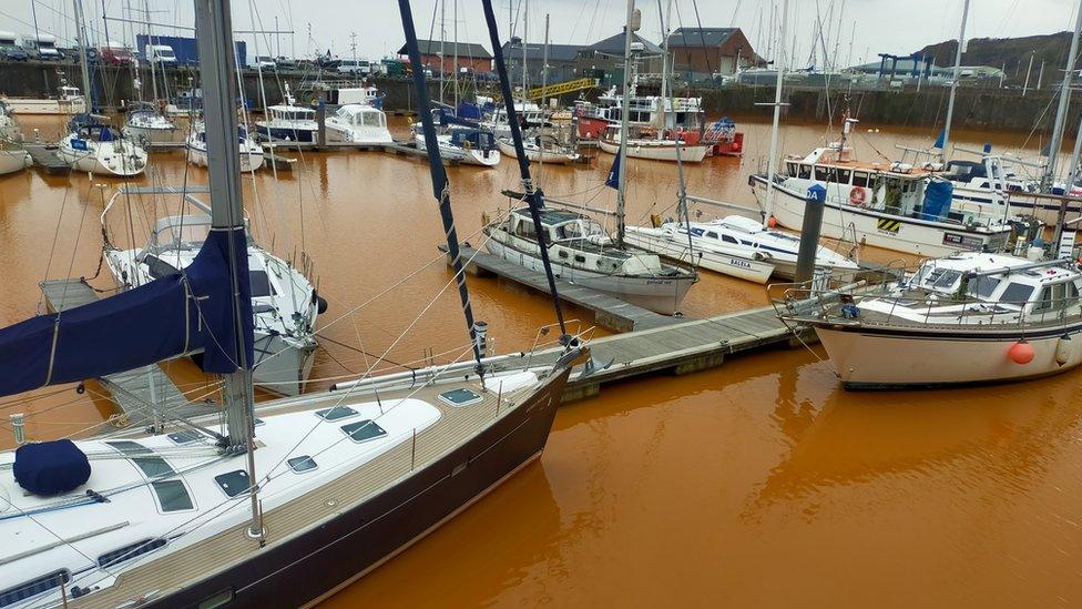 The orange coloured water in Whitehaven Harbour