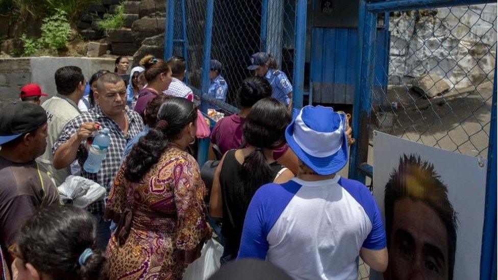 Relatives and friends of a detained student gather in front of El Chipote jail.