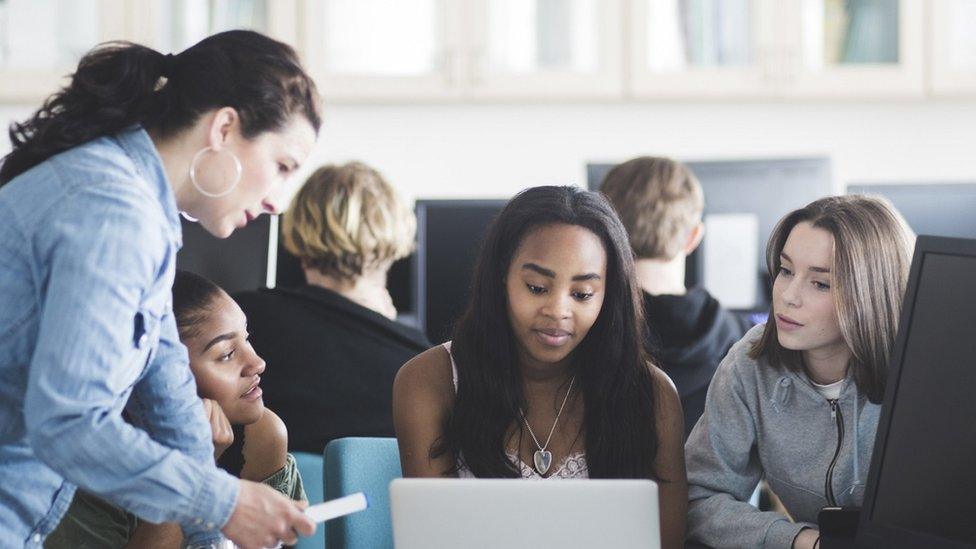 Stock image of a teacher and students