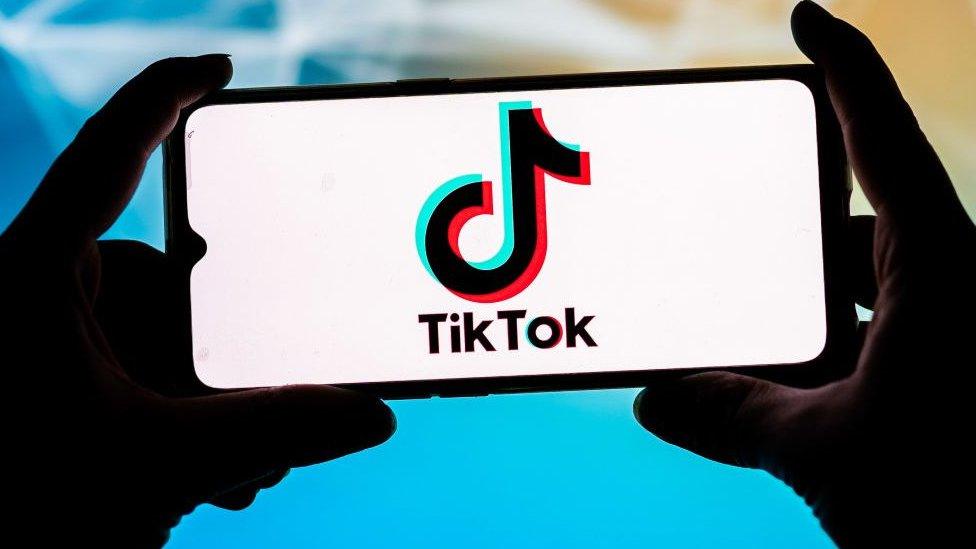 An illustration of the tiktok logo on a smart-phone