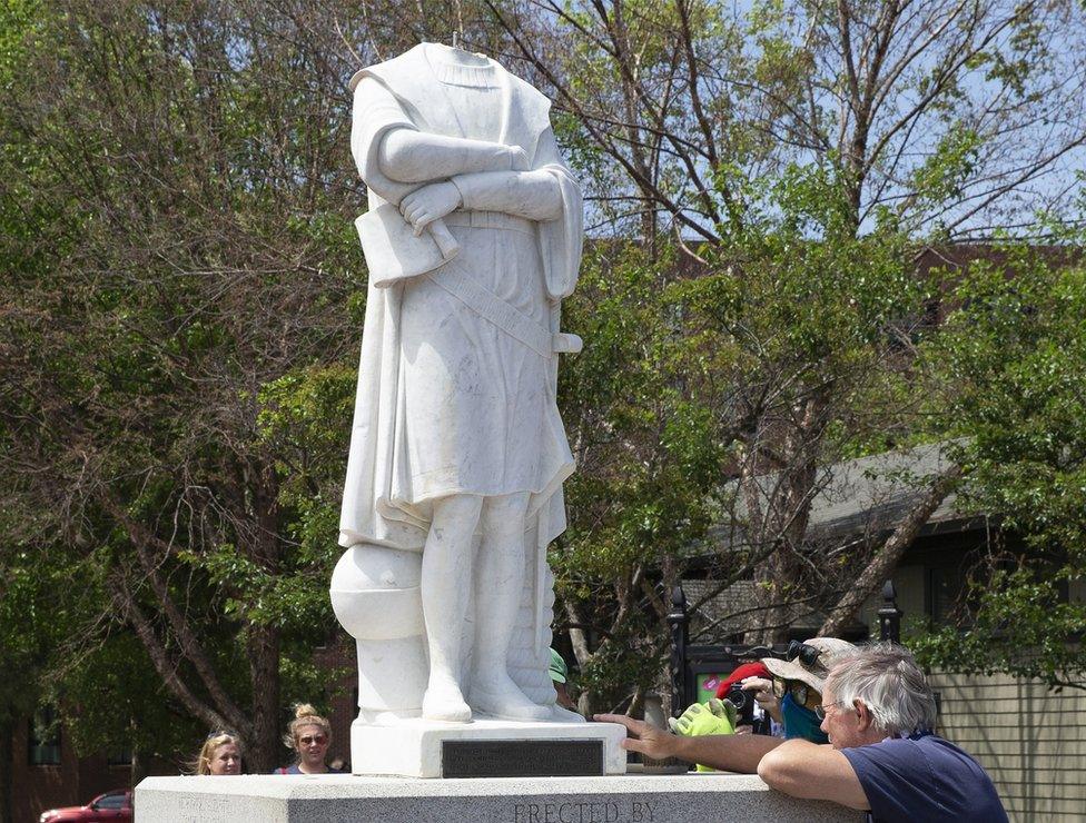 City employees inspect the decapitated statue of Christopher Columbus in Columbus Park in Boston, Massachusetts, 10 June 2020