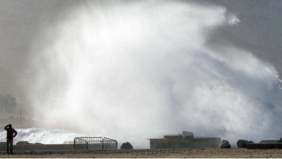 Man watches waves at beach in Marseille, France - 4 January