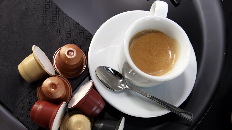 Biodegradable capsules by Ethical Coffee Company (ECC) lie next to a ciup of coffee prior a press conference in Geneva, Switzerland, 23 March 2015