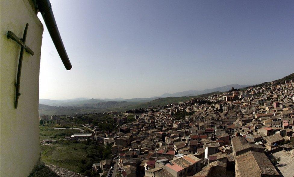 A crucifix towers over Corleone, Italy, the ancestral home and surname of the title characters in The Godfather novel and films