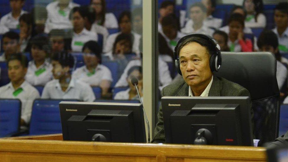 Soy Sen wearing headphones in the trial chamber